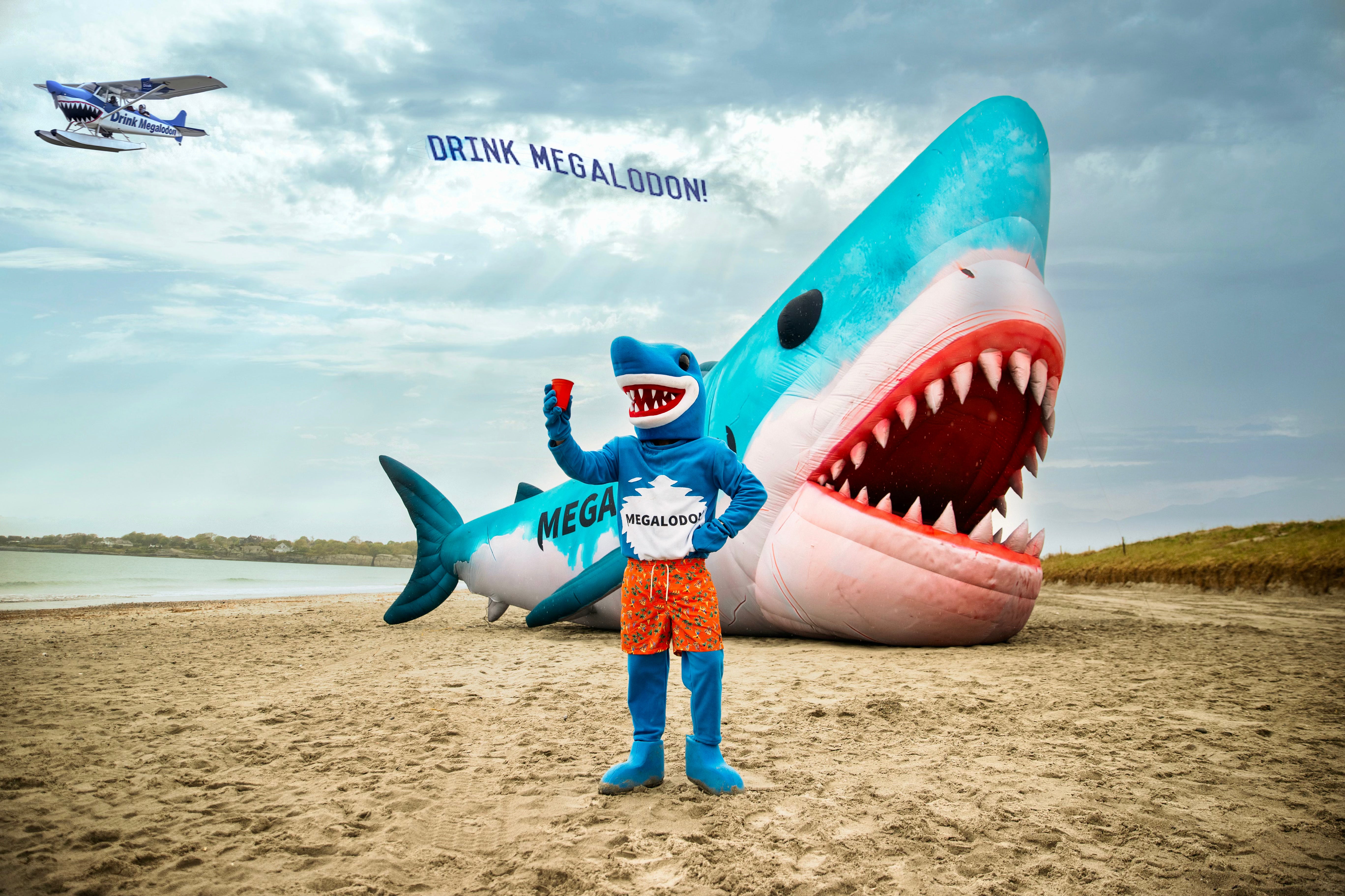 Megalodon's Don cheers-ing at the beach
